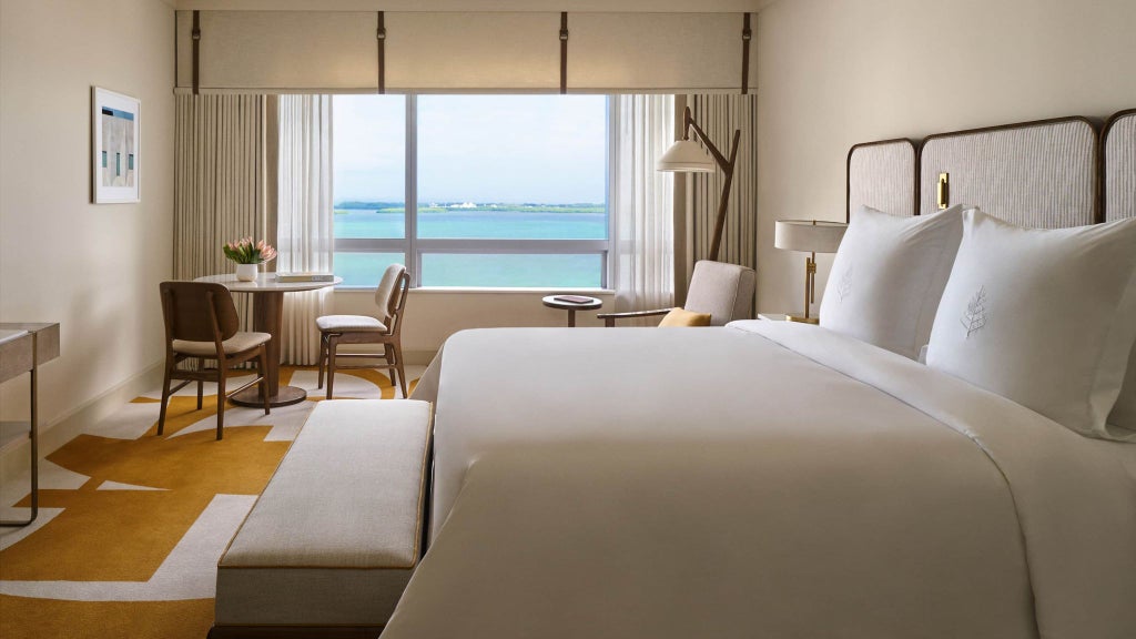 Luxurious premier bayfront room at Four Seasons Hotel Miami, featuring sleek modern design with panoramic ocean views and contemporary floor-to-ceiling windows