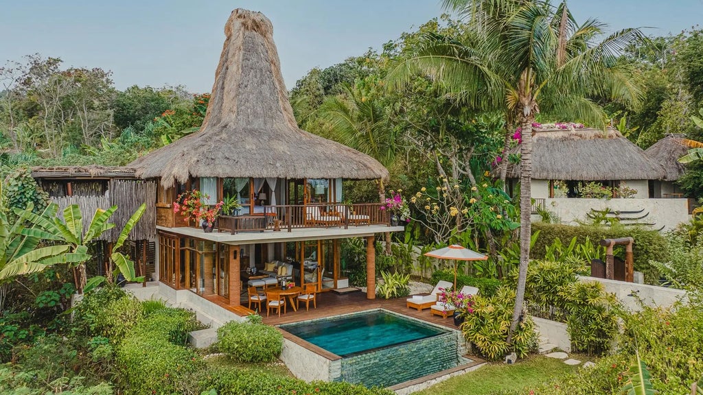 Spacious luxury wooden villa overlooking lush tropical landscape, with open-air design, private infinity pool, and panoramic views of Sumba's pristine coastline