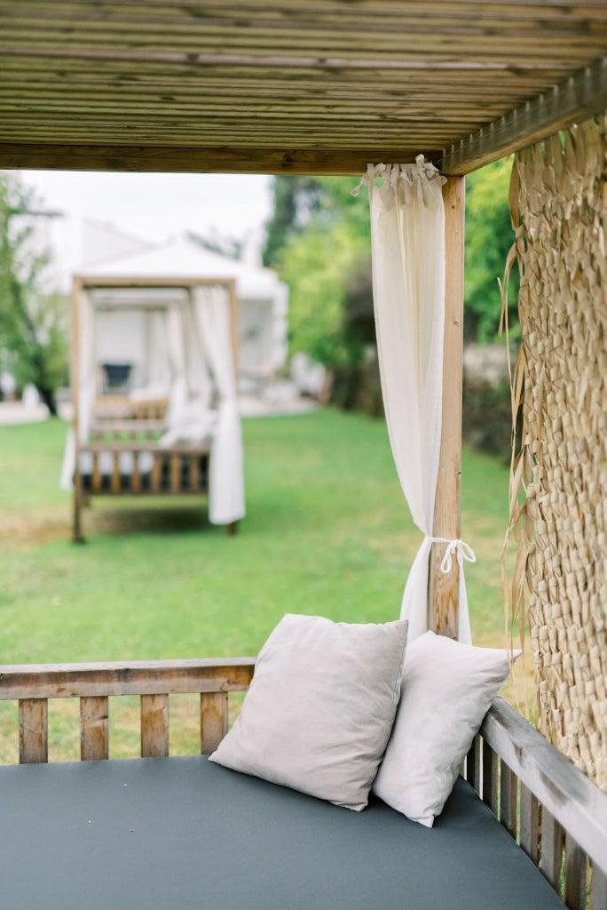 Traditional Portuguese rural guesthouse with stone walls, wooden balcony, and lush green landscape, showcasing rustic charm and serene countryside ambiance