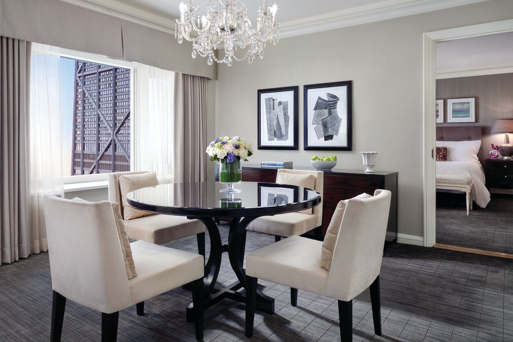 Elegant Hotel Four Seasons Chicago exterior featuring limestone facade, classic architecture, and floor-to-ceiling windows overlooking downtown