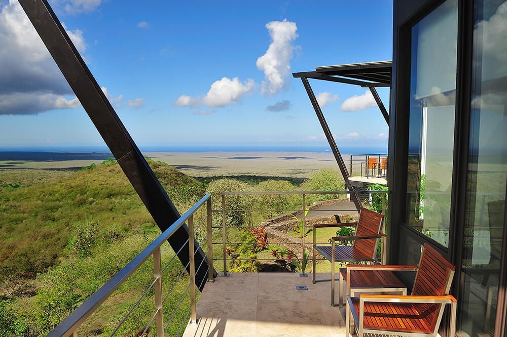 Luxurious balcony room at Pikaia Lodge overlooking lush Ecuadorian landscape with modern design, private terrace, and panoramic natural scenery