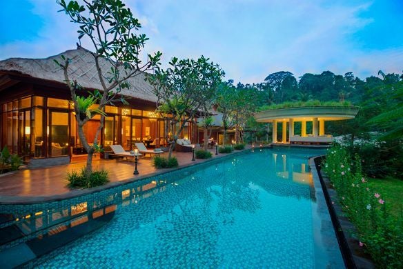 Luxurious rainforest villa with infinity pool overlooking Ubud's lush valley, featuring traditional Balinese architecture and green terraces