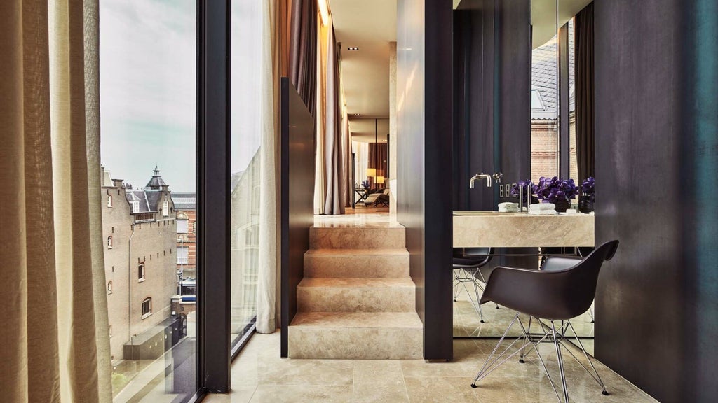 Luxurious penthouse suite with modern design, floor-to-ceiling windows, minimalist furnishings, and sweeping city views of Amsterdam's historic landscape