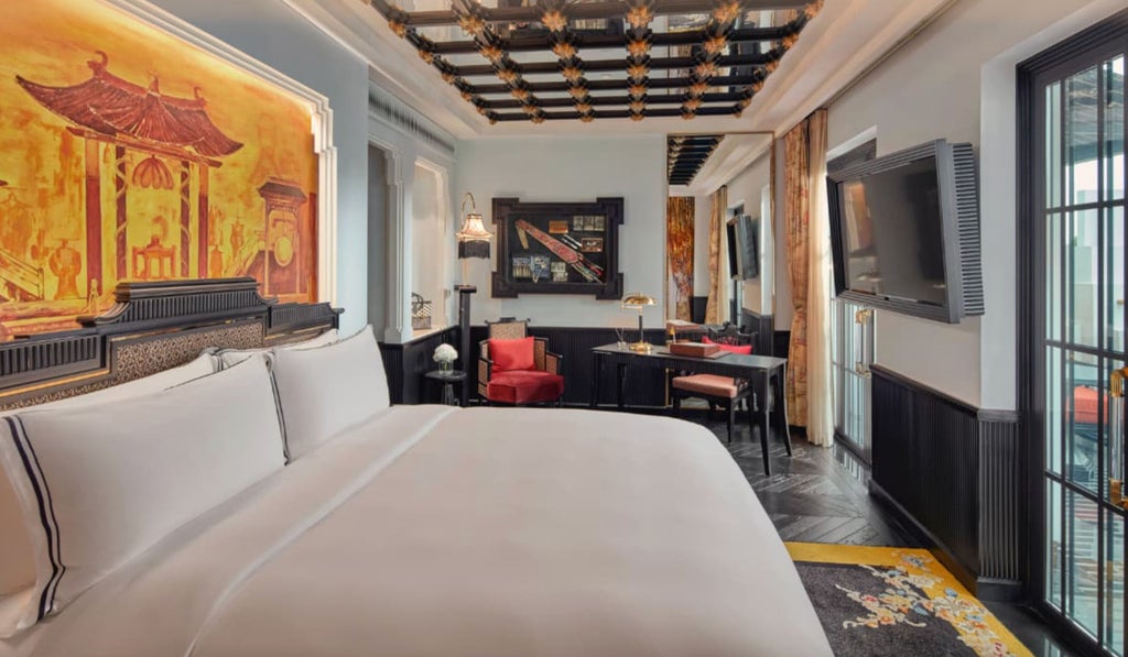 French colonial-style luxury suite with private terrace overlooking Hanoi Opera House, featuring ornate decor and antique furnishings