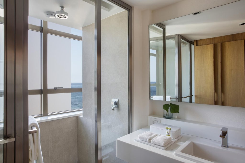 Contemporary luxury hotel room with ocean view, sleek minimalist design, floor-to-ceiling windows, neutral color palette, and Brazilian coastal aesthetic in Janeiro Hotel