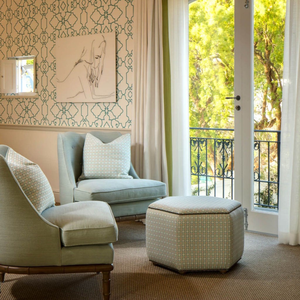 Luxurious pool suite at scenset hotel with crisp white linens, elegant pool view, and modern African-inspired decor in warm neutral tones