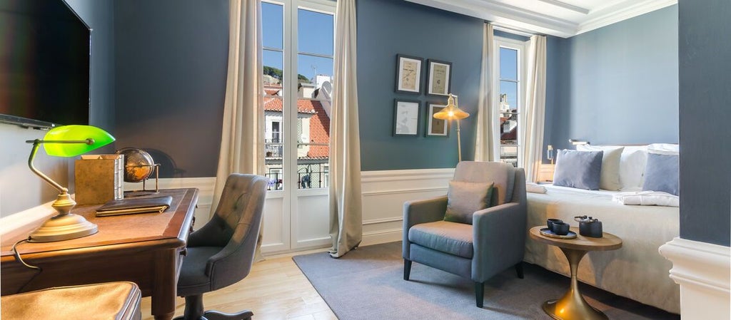 Elegant deluxe hotel room in Porto's historic district, featuring polished wooden floors, modern furnishings, and expansive city view through large windows