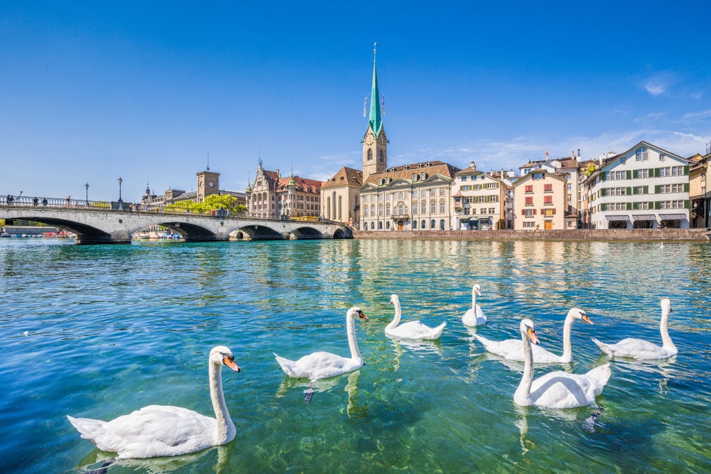 Elegant guided tour through Zurich's historic Old Town, showcasing Swiss architectural splendor with medieval buildings and cobblestone streets against Alpine backdrop