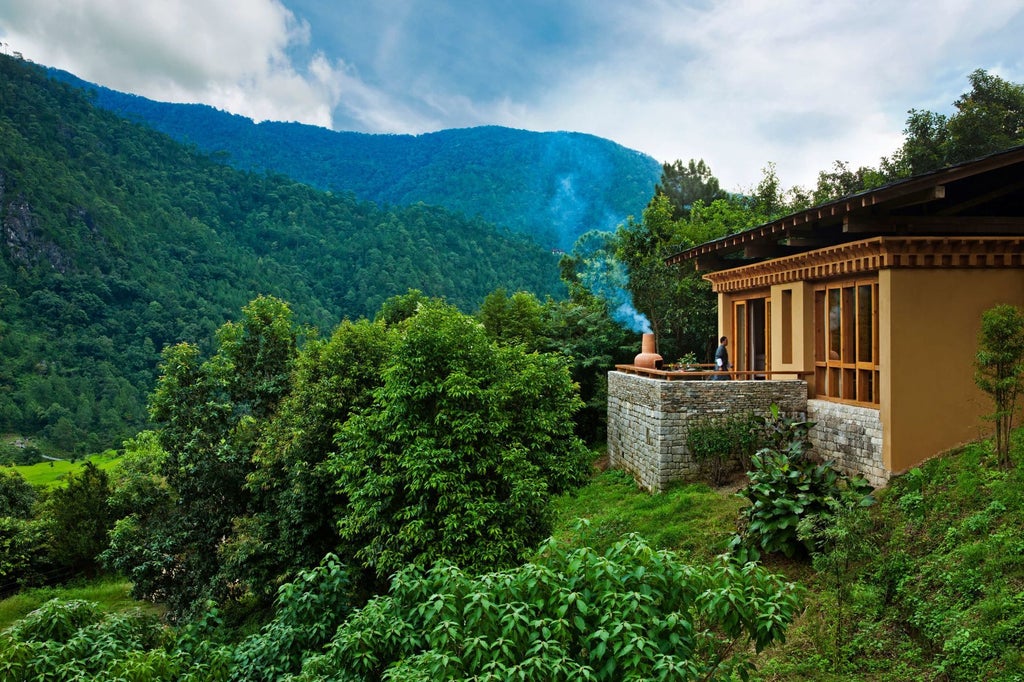 Luxurious COMO Uma Punakha hotel nestled in Bhutan's lush Punakha Valley, showcasing traditional Bhutanese architecture with sweeping mountain landscape views