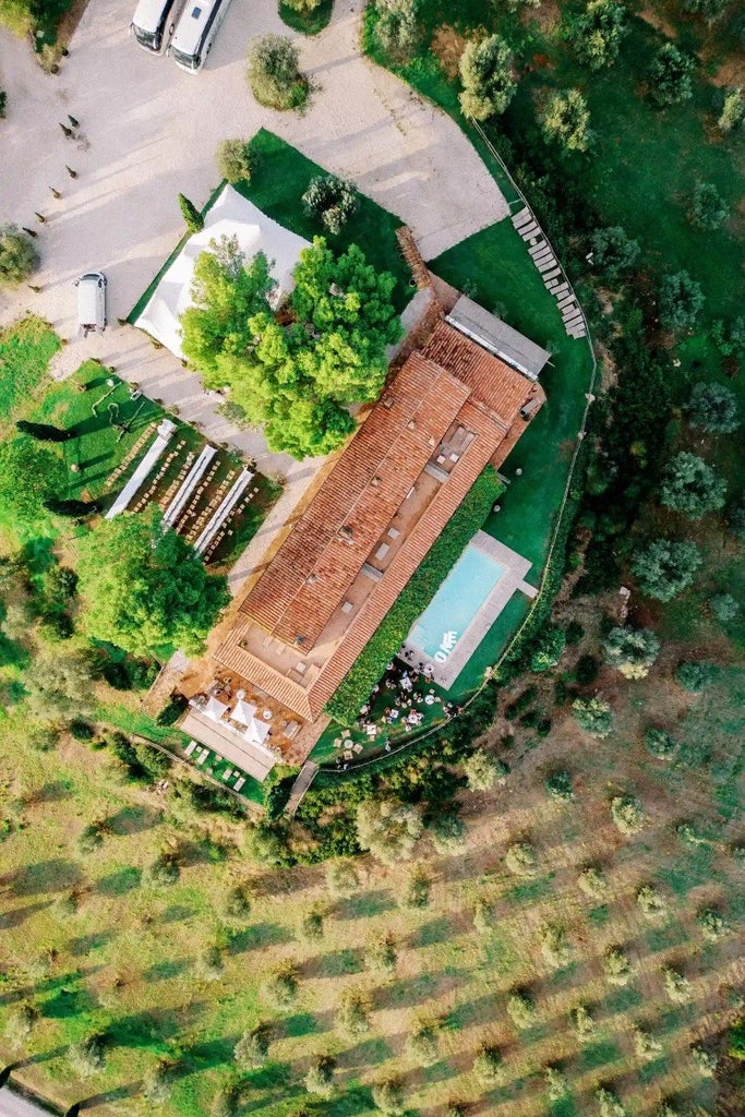 Luxurious Tuscan wine resort nestled among rolling vineyards, with rustic stone architecture and elegant cypress trees under golden sunset light