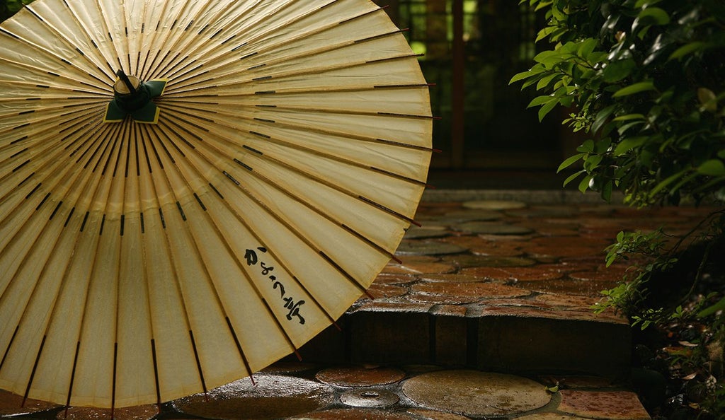 Minimalist traditional Japanese ryokan with elegant wooden architecture, nestled in serene forest landscape with soft natural lighting and tranquil mountainous background