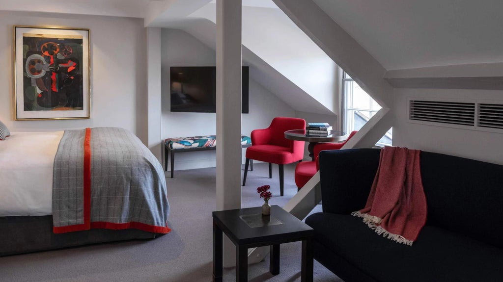 Elegant junior suite with period furnishings, rich wooden floors, and large windows overlooking historic United Kingdom architecture in a converted bank building