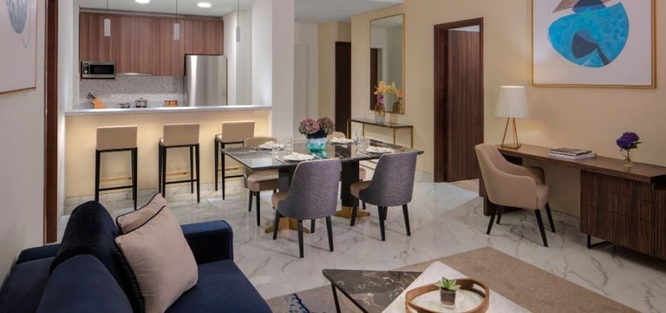 Spacious, modern two-bedroom suite at Scenset+ Palm View Dubai Hotel, featuring sleek furnishings, panoramic city views, and contemporary Arabian design aesthetic