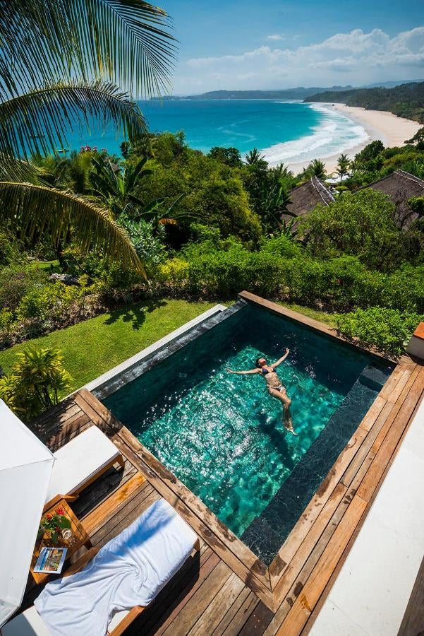 Luxurious oceanfront villa at NIHI Sumba with private infinity pool overlooking turquoise waters and white sandy Indonesian beach