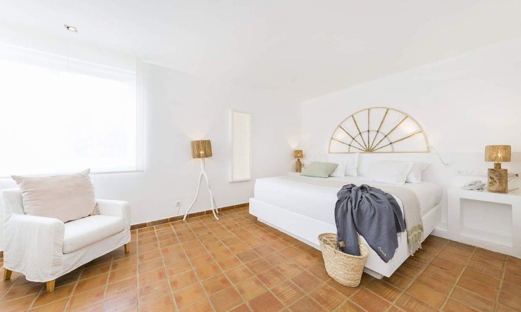 Luxurious suite with panoramic views of mountains and ocean, featuring elegant white decor, spacious bedroom, and contemporary Portuguese design aesthetic