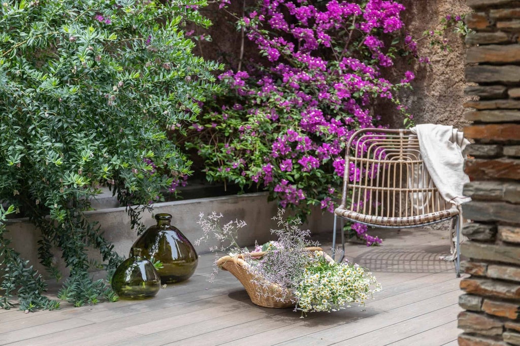 Elegant superior hotel room with private terrace, contemporary Spanish design, soft neutral tones, and minimal modern furnishings overlooking scenic landscape