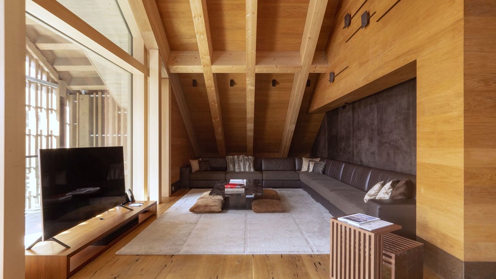 Opulent Swiss alpine suite with floor-to-ceiling windows, modern chalet-style design, minimalist wood furnishings, and sweeping mountain landscape view