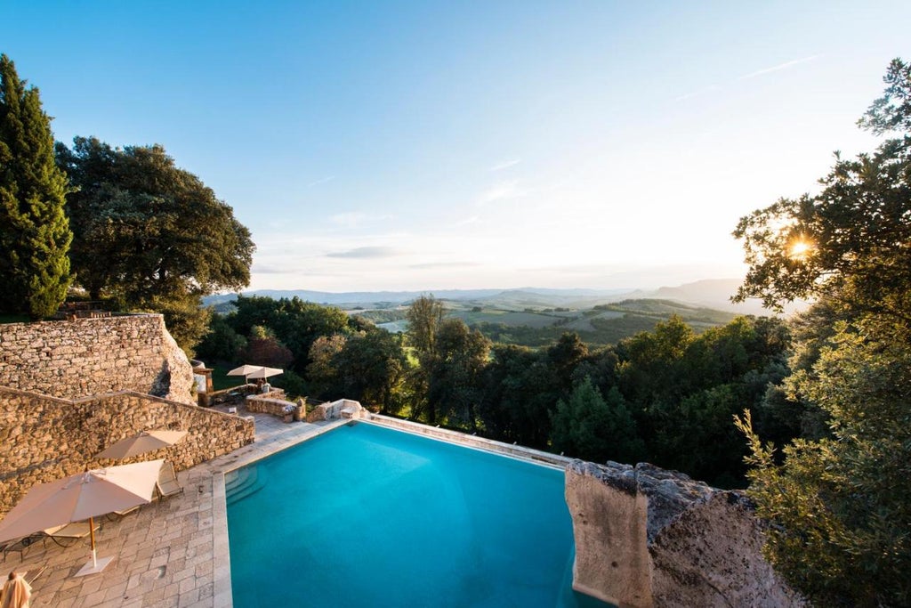 Historic Tuscan villa with honey-colored stone facade surrounded by manicured gardens and cypress trees in scenic hillside setting