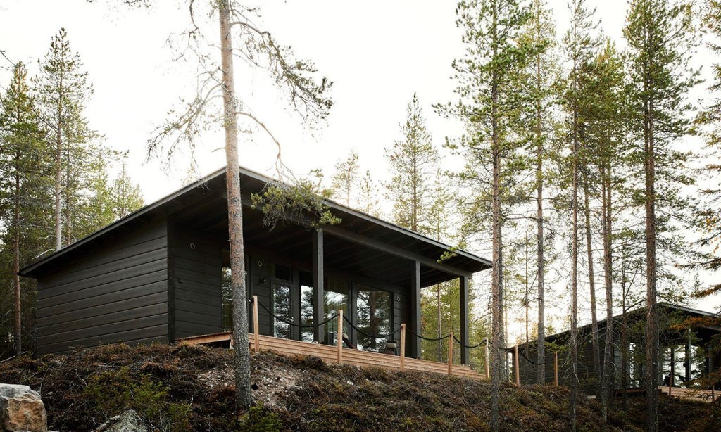 Modern Scandinavian wood cabin suite with panoramic glass wall overlooking snowy Nordic landscape, minimalist design and warm ambient lighting