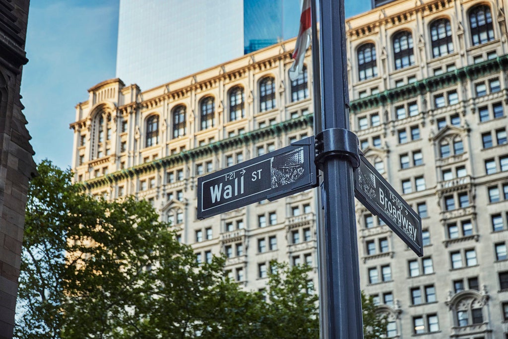 Elegant limestone skyscraper hotel in Lower Manhattan with art deco design elements, reflective glass windows and modern architectural details