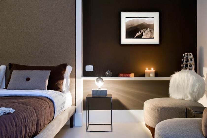 Elegant Roman hotel room with soft neutral tones, luxurious white linens, modern minimalist decor overlooking historic Piazza di Spagna area in central Rome