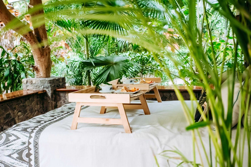 Luxurious beachfront villa with panoramic ocean views, white sand, traditional Fijian design, and elegant interior featuring natural wood and tropical decor