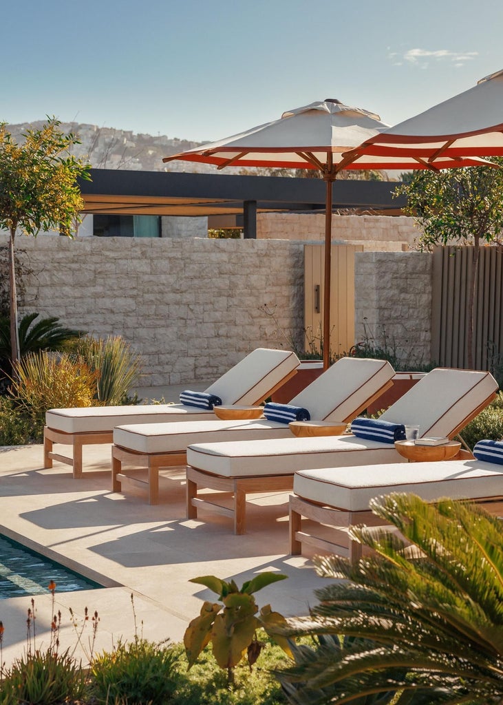 Elegant white-washed villa with minimalist design, featuring infinity pool overlooking Aegean Sea, smooth stone textures and serene Mediterranean landscape