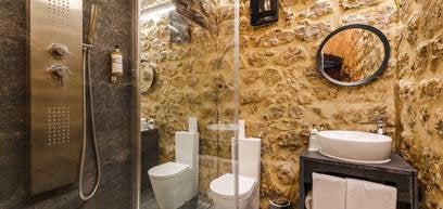 Historic stone castle hotel perched on hilltop in Obidos, Portugal, featuring medieval architecture with cream-colored walls and red tile roofs