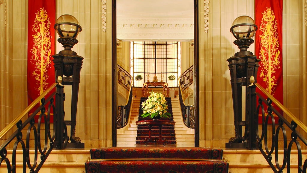 Elegant cream-colored high-rise hotel with French-inspired architecture, manicured gardens and grand circular driveway entrance in Buenos Aires