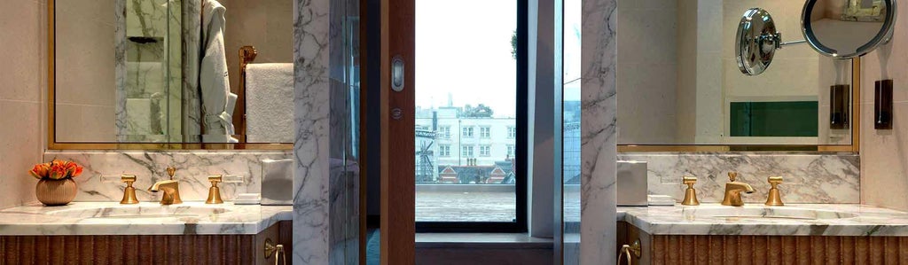 Luxurious hotel suite with plush king bed, elegant cream and gray color palette, large windows overlooking urban scenery in a refined UK hotel room