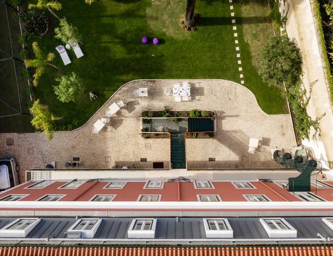 Elegant five-star hotel with Moorish-inspired architecture, featuring white archways, ornate balconies and a grand central courtyard garden