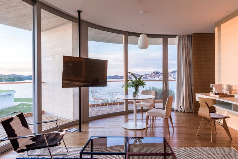 Luxurious hotel suite in scenset with panoramic sea view, modern design, elegant furnishings, and spacious balcony overlooking Croatian coastline