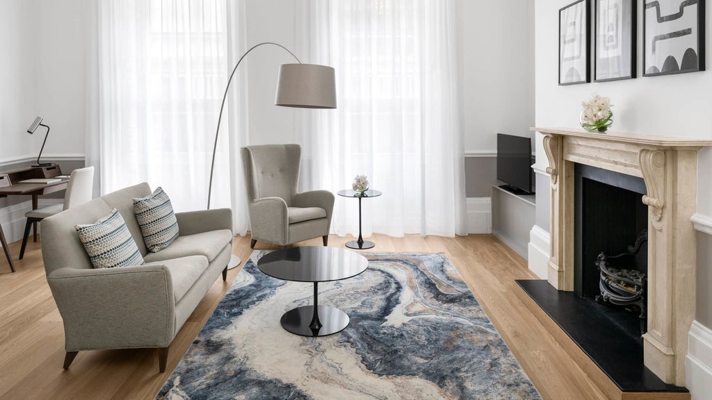 Luxurious COMO Suite with elegant contemporary design, plush white bedding, and modern minimalist furniture in COMO Metropolitan London hotel