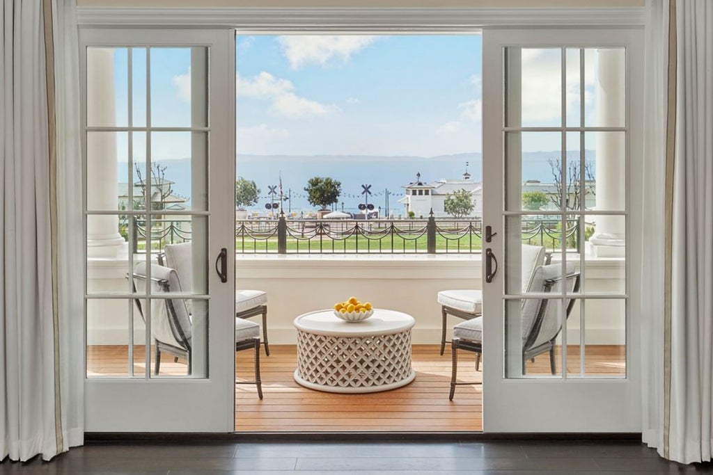 Luxurious beach house terrace suite at Rosewood Miramar Beach with coastal California styling, oceanic views, and elegant outdoor seating area