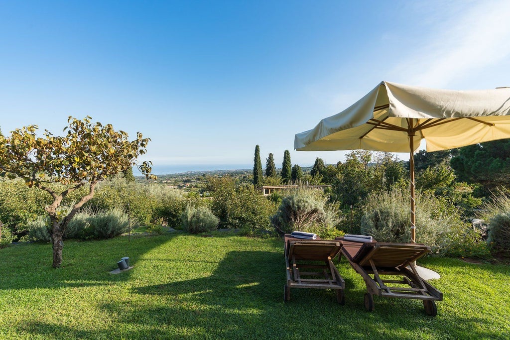 Elegant four-bedroom pool villa at Monaci delle Terre Nere, nestled in Sicilian landscape with contemporary design and lush vegetation backdrop