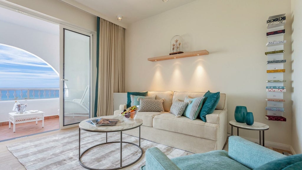 Spacious two-story luxury townhouse suite with elegant white and blue decor, private terrace, and modern Portuguese coastal resort design at Vila Vita Parc