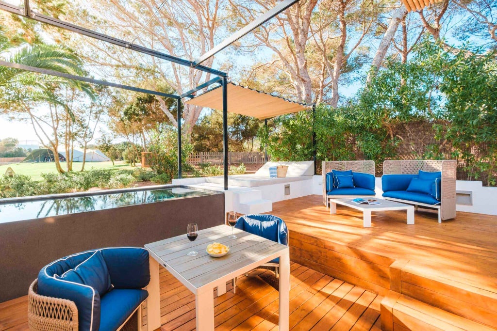 Luxurious poolside corner at Gecko Hotel & Beach Club, featuring sleek sun loungers, pristine blue pool, and Mediterranean coastal backdrop in Spain