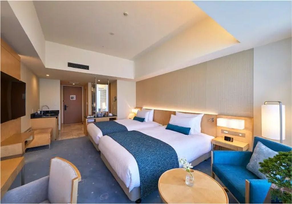 Elegant Premier hotel room with plush queen beds, city views, marble bathroom, rich wood furnishings and traditional Japanese decor details