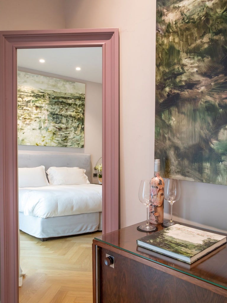 Elegant deluxe hotel room with artistic gallery-style decor, Italian minimalist design, large windows overlooking urban landscape, contemporary luxe furnishings