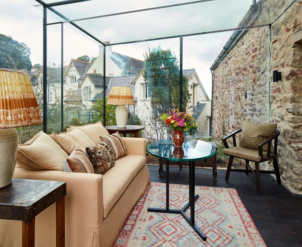 Luxurious rustic bedroom with exposed wooden beams, elegant white bedding, and soft natural light in a charming countryside hotel suite at Grove of Narberth