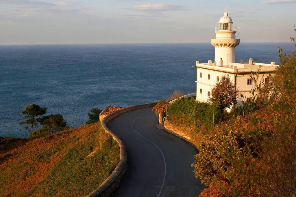 A vibrant coastal sunset over San Sebastian's La Concha Bay, with elegant beachfront promenades and historic Belle Époque architecture