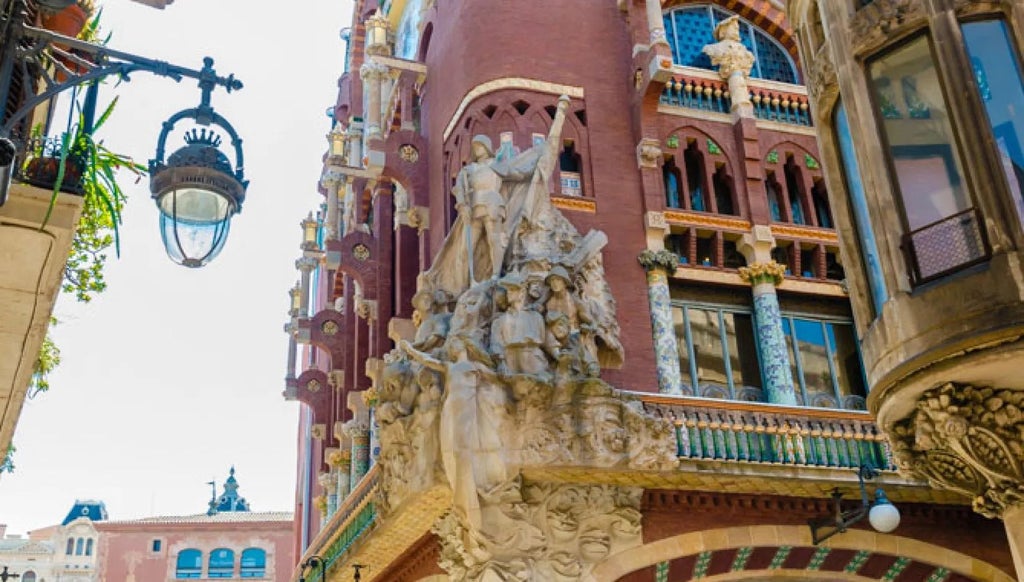 Luxurious landmark hotel with elegant Spanish architectural details, marble lobby, and grand chandelier in Barcelona's historic city center