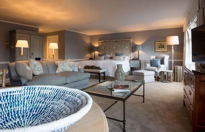 Elegant junior suite at Scenset Glen Hotel & Spa, featuring plush king bed, contemporary decor, soft neutral tones, and luxurious spa-inspired bathroom with natural light