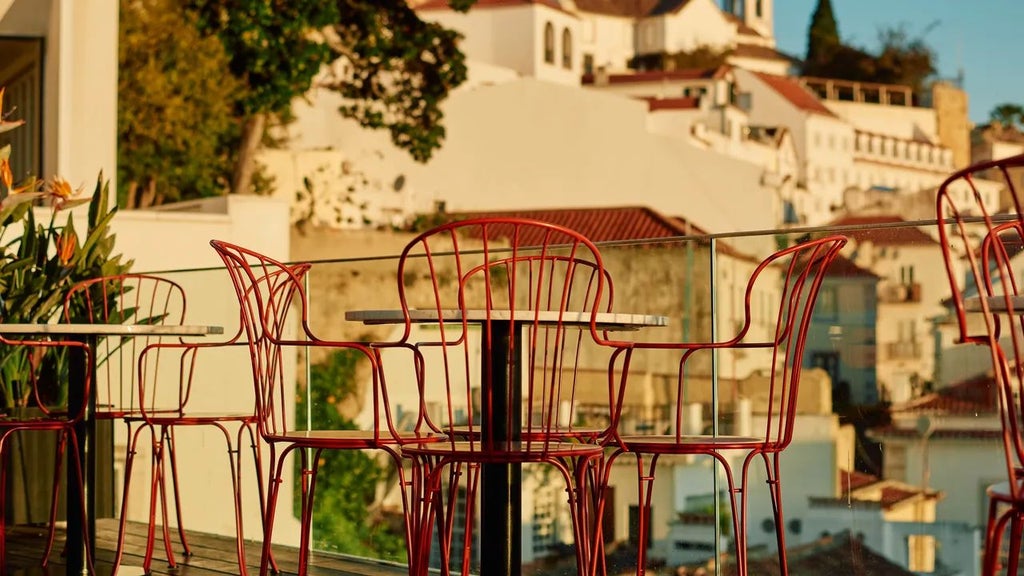 Luxurious boutique hotel overlooking Lisbon's historic Alfama district, with traditional terracotta rooftops and stunning cityscape in warm golden light