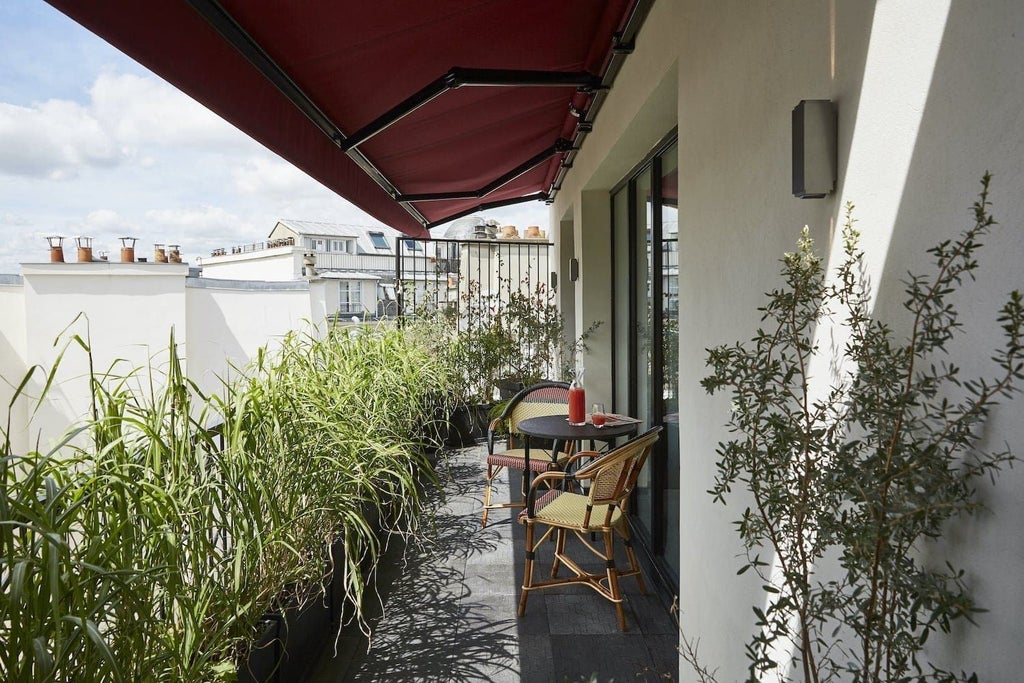 Elegant Parisian hotel facade with chic stone exterior, ornate balconies, and classic French architectural details, showcasing refined luxury in the heart of urban scenset