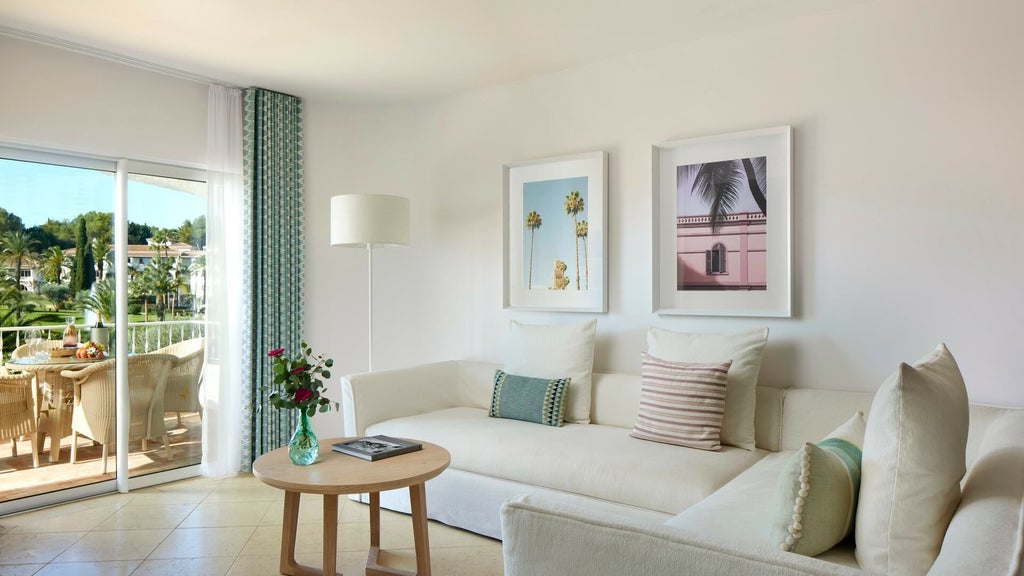 Spacious luxury family suite with ocean-view balcony, modern Portuguese decor, plush king bed, and elegant seating area at Vila Vita Parc Resort in Algarve