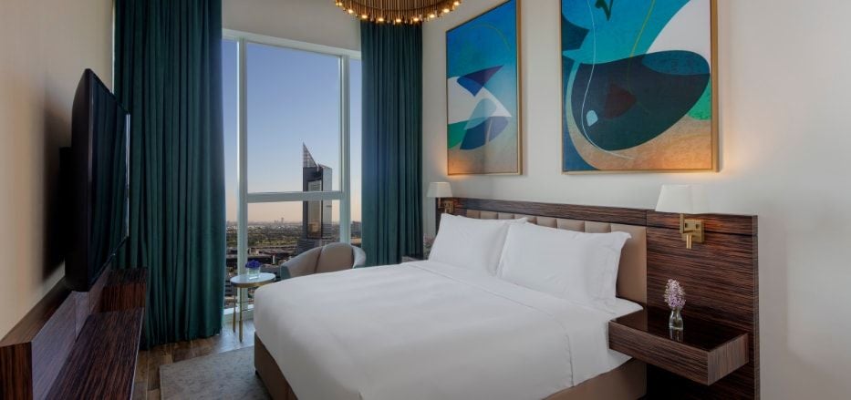 Modern, spacious two-bedroom luxury apartment with sleek furnishings, large windows, contemporary decor, and panoramic city views in Dubai hotel suite