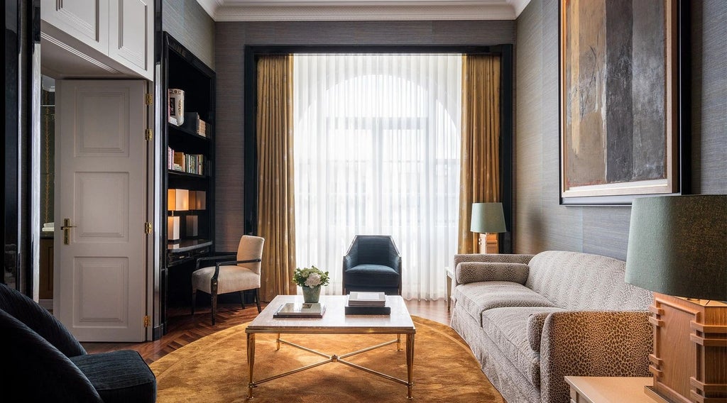 Elegant Monumentale Suite at Le Monumental Palace, featuring opulent gold-trimmed furnishings, plush king bed, and refined Porto architectural heritage