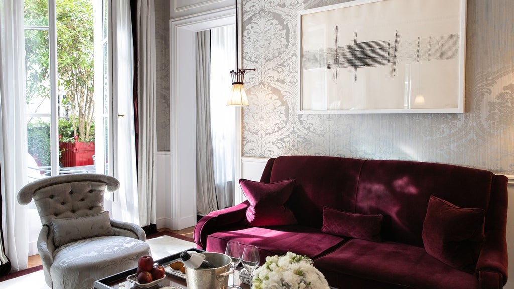 Elegant Parisian junior suite with private terrace, featuring sophisticated contemporary decor, plush furnishings, and sweeping cityscape views of France's capital.