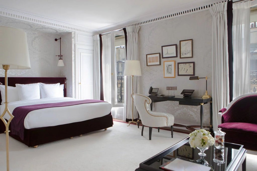 Elegant Prestige Junior Suite at La Réserve Paris Hotel & Spa, featuring plush cream armchairs, rich wood furnishings, and soft neutral color palette